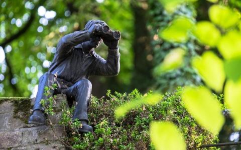 statue of man with binoculars